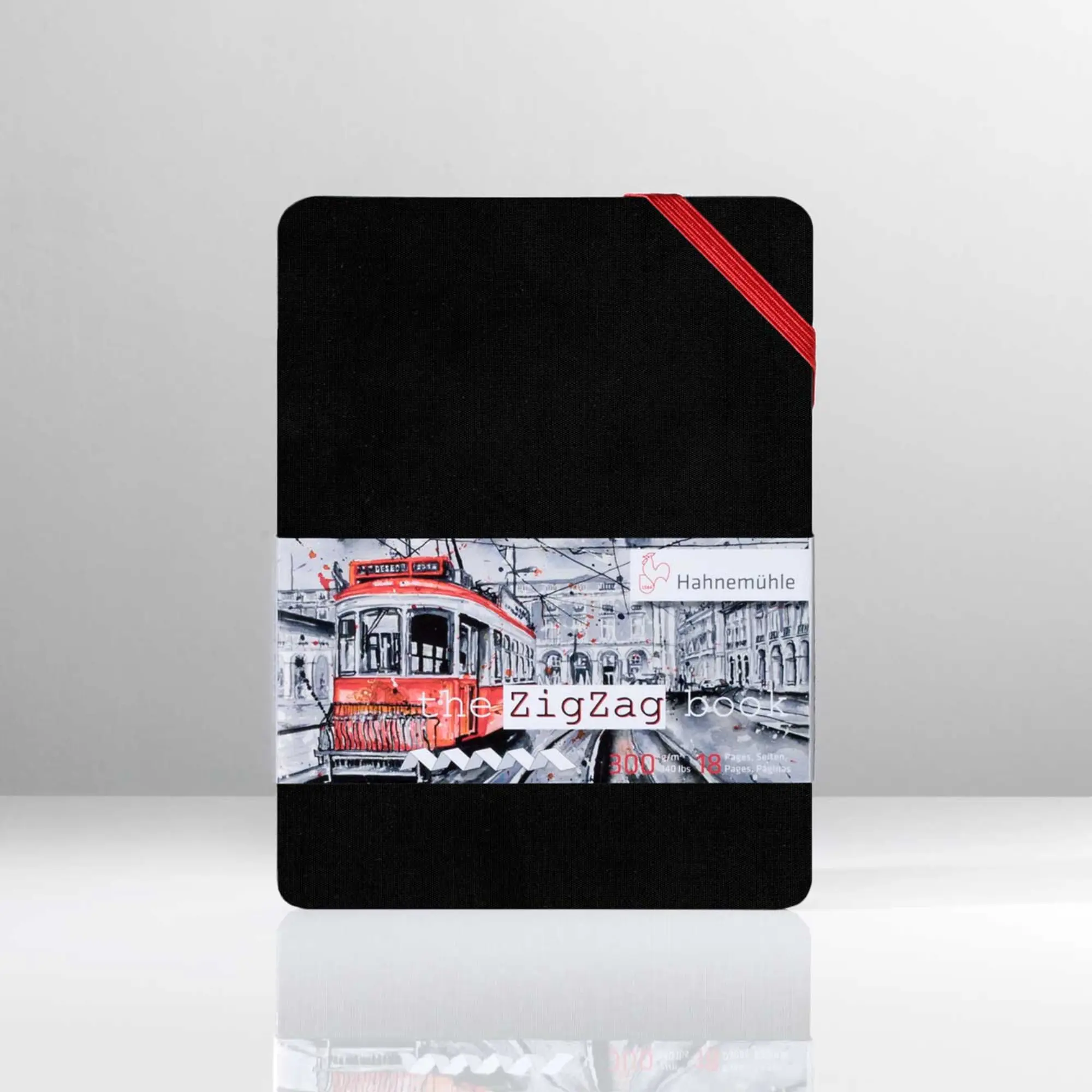 notebook, black cover, red elastic band, railway image, banded wrap