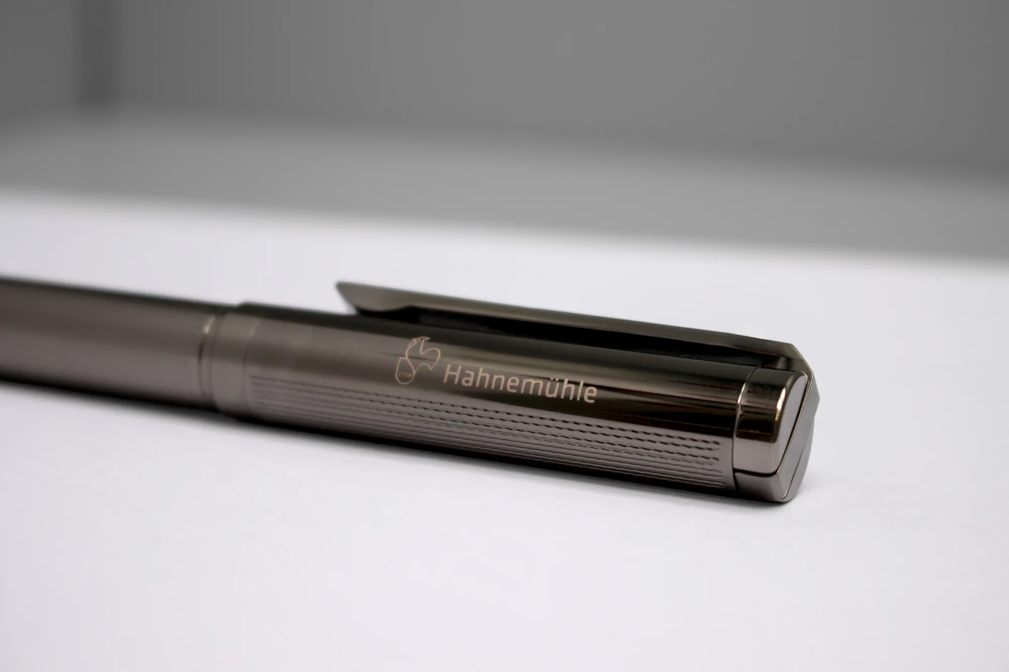 ballpoint pen, metallic, clip, twist mechanism, brand name visible