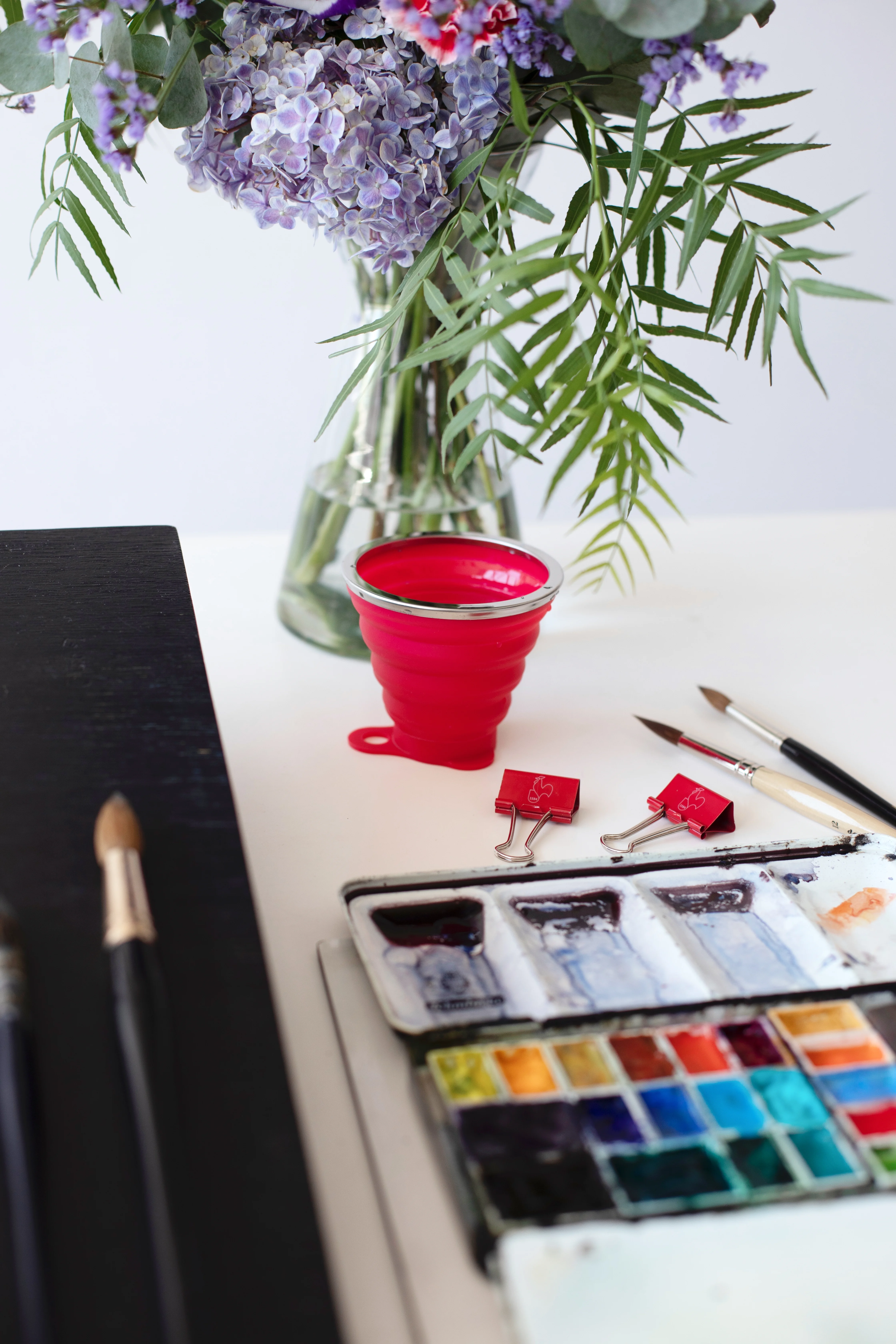 watercolor set, paint palette, paint brushes, flower bouquet, est acrylic cup