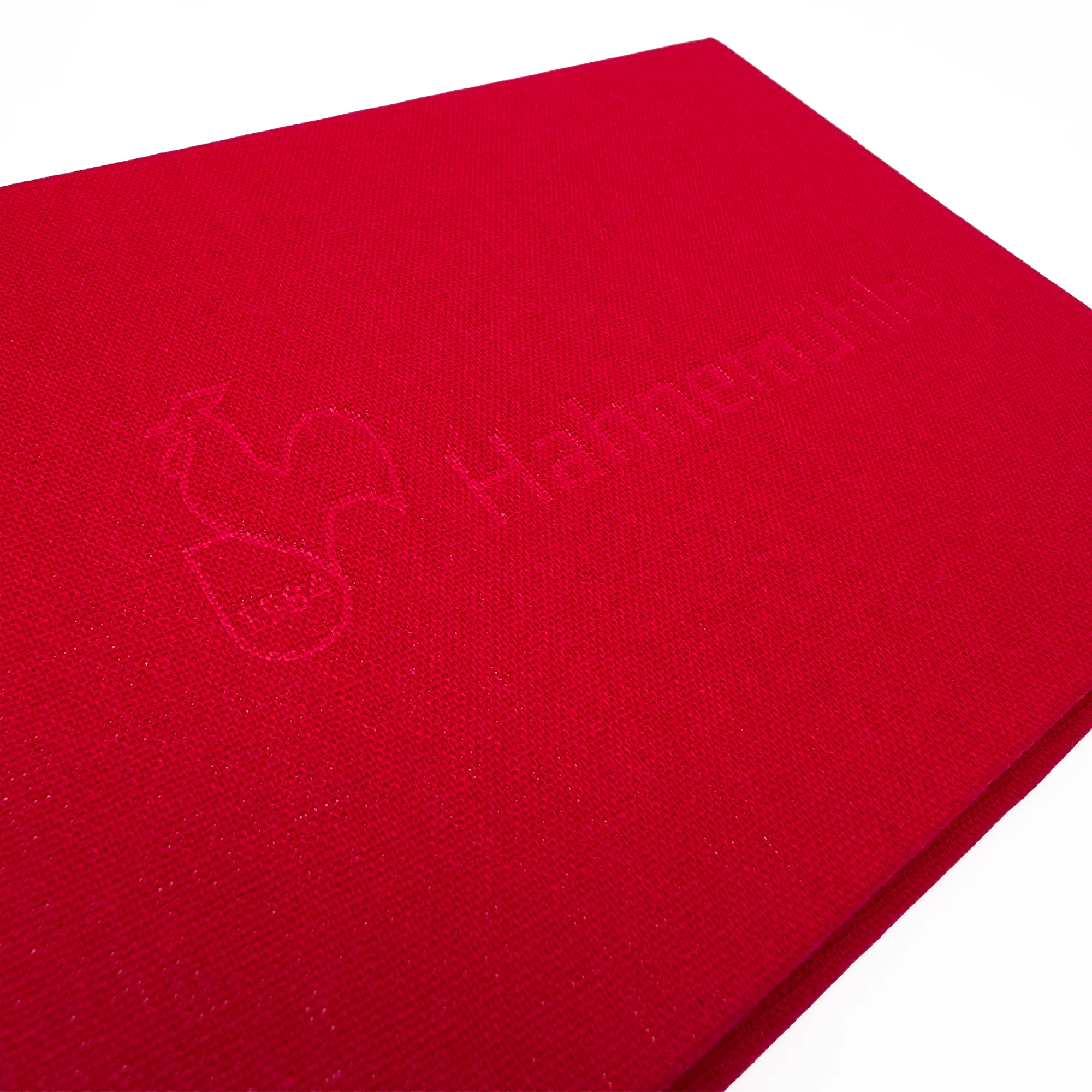 red fabric, textured textile, folded cloth, handkerchief, embossed text